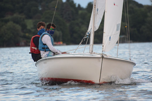 adults sailing a boat